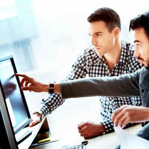 Three people looking at a computer screen